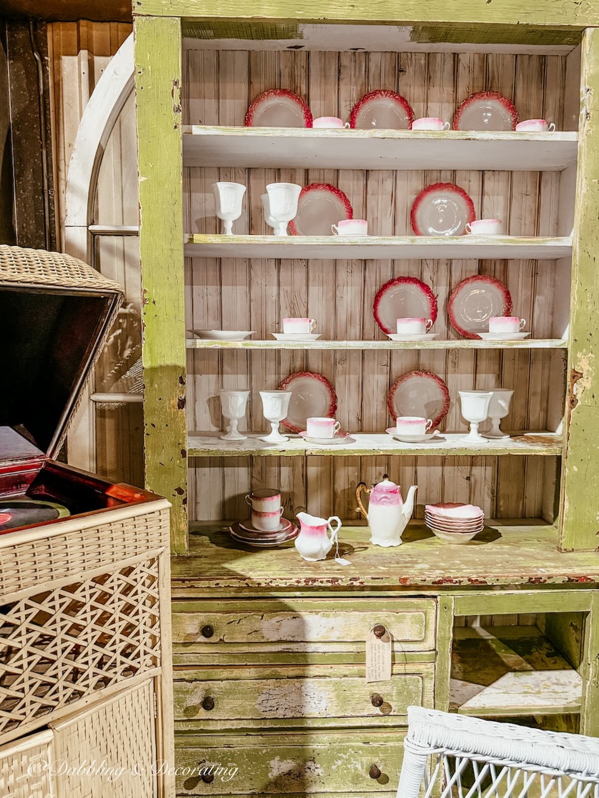 Lime green vintage hutch with antique pink and white dish collection displayed at The Antique Warehouse Hudson, NY