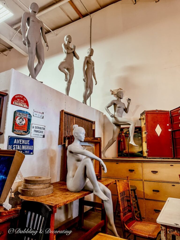 5 mannequins in various positions from running to yoga at vintage booth display at The Antique Warehouse Hudson, NH