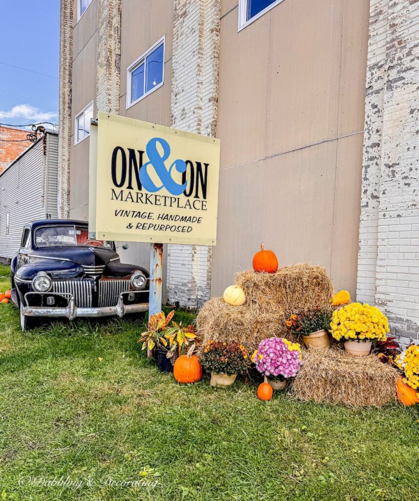On&On vintage and antique shop in Scranton, Pennsylvania decorated outside with antique black car, pumpkins and hay bales.