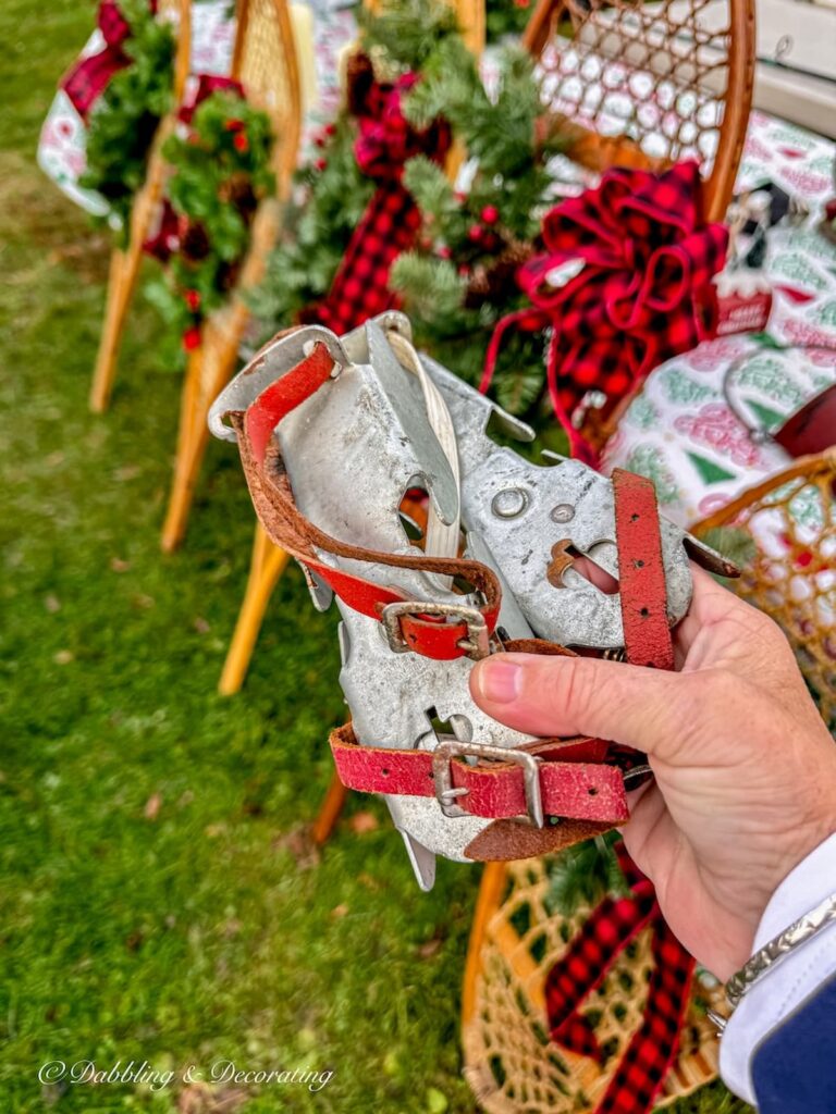 Vintage children's metal ice skate runners with red straps at Todd Farm Flea Market in hand.