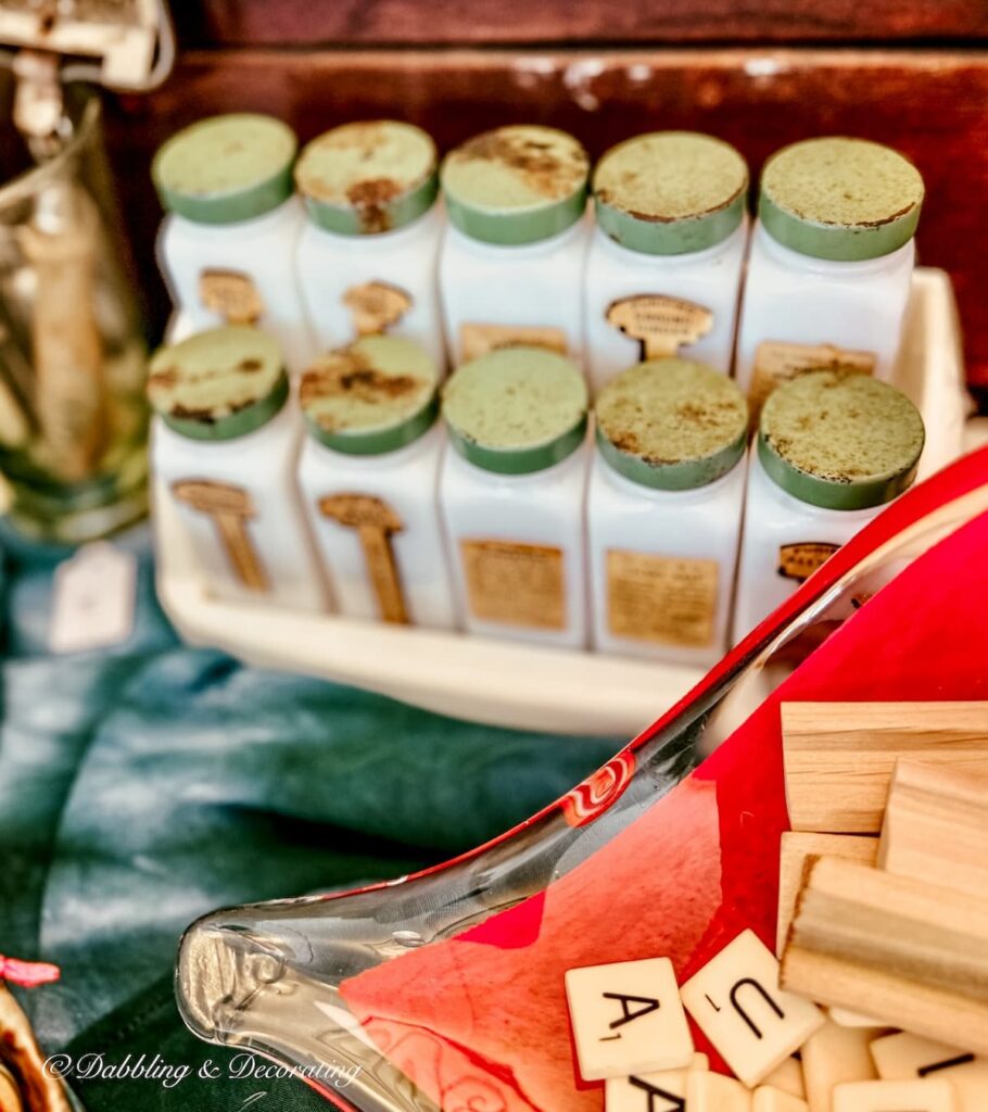 Set of milk glass vintage spices in a bakelite container with green tops and labels.