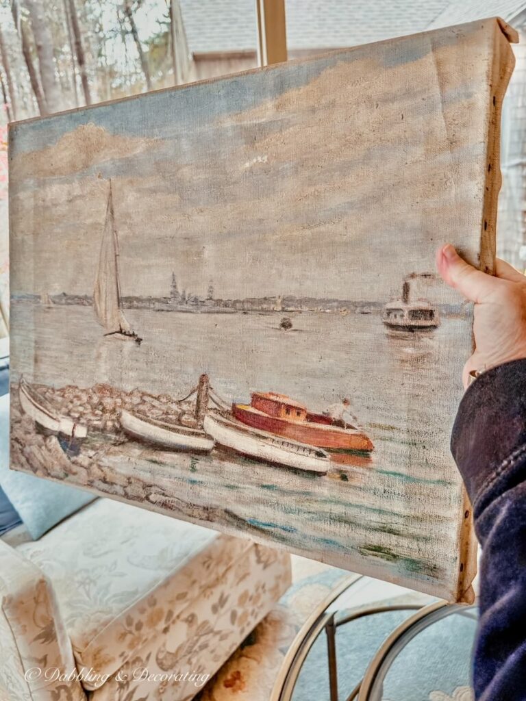 Pastel coastal sailboat oil painting canvas on wood from the Todd Farm Antiques and Flea Market in Rowling, Massachusetts in hand.