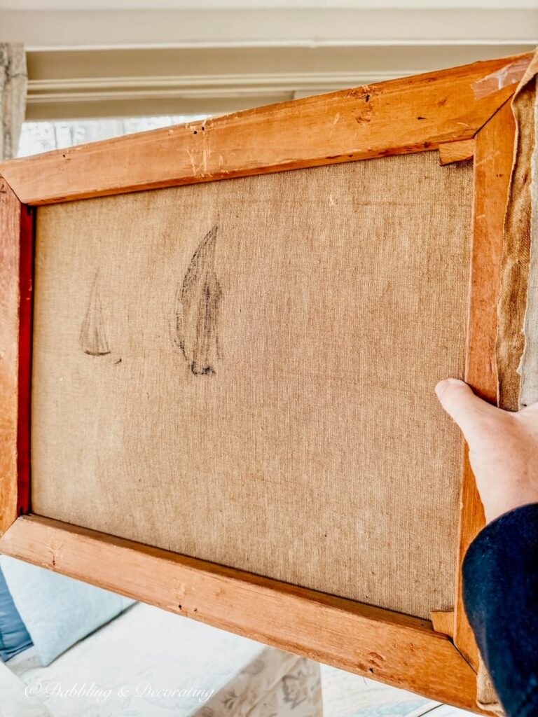 The back of an oil painting canvas with two sailboat drawings in hand from Todd Farm Antiques and Flea Market.