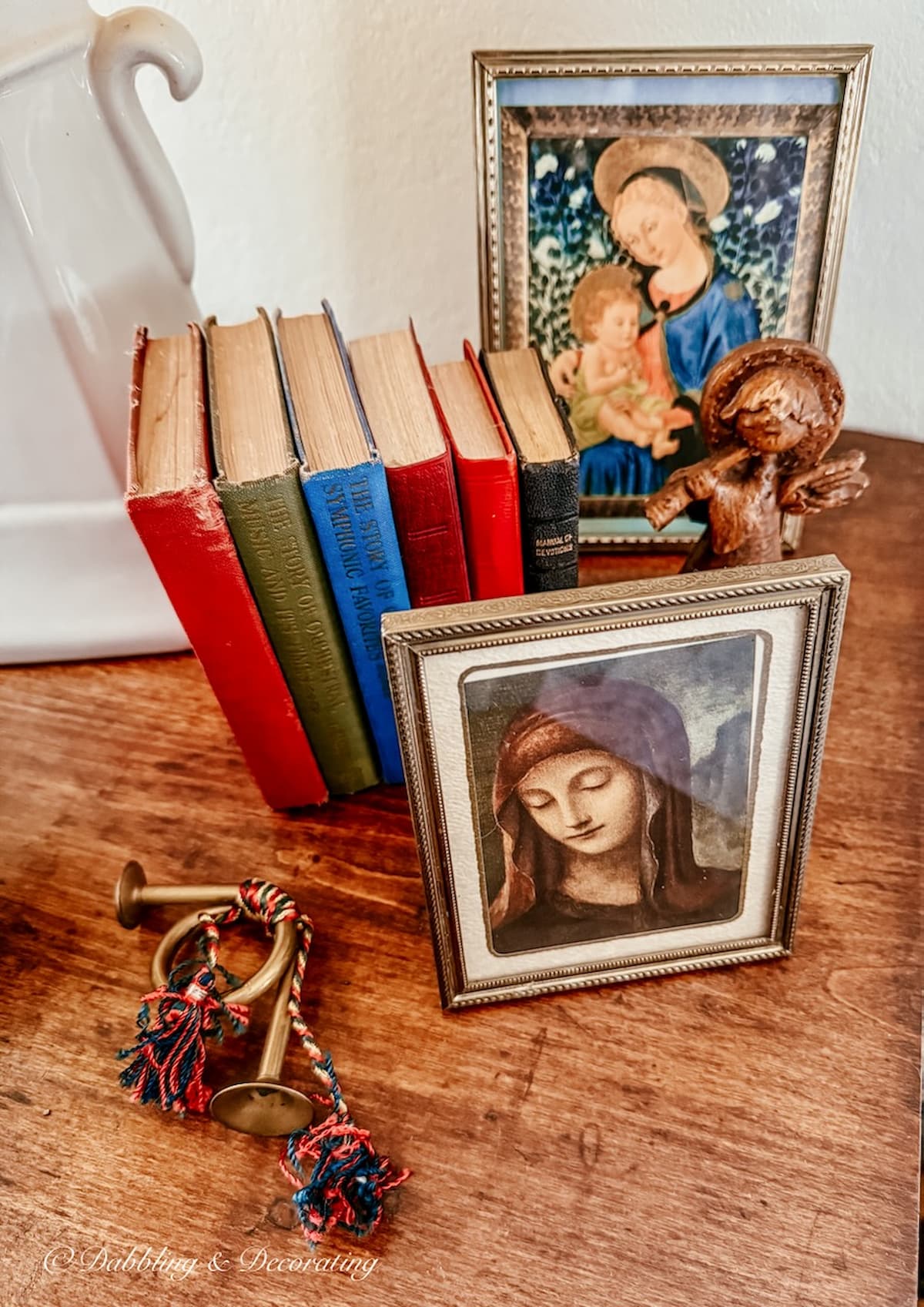 Vintage Christmas Decorations: Small framed pictures of Mary with small vintage bibles on bedside table.