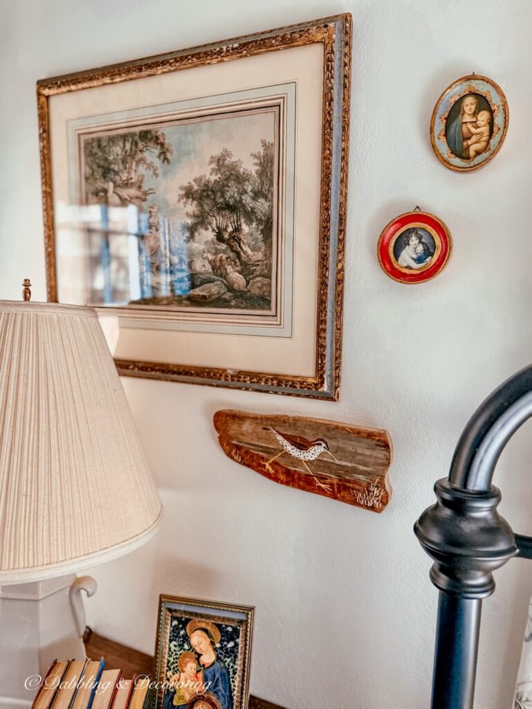 Vintage Christmas Decorations: Two small framed Mother Mary religious pictures on bedroom wall.