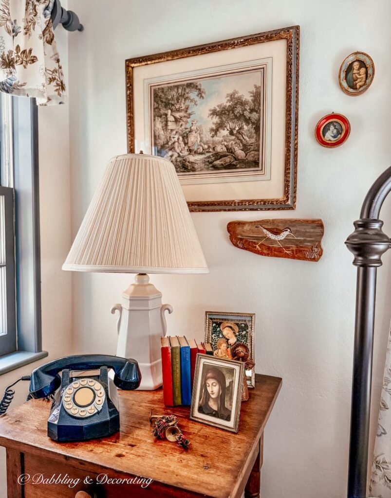 Antique bedroom side table with vintage Christmas decorations, telephone and coastal decor details.