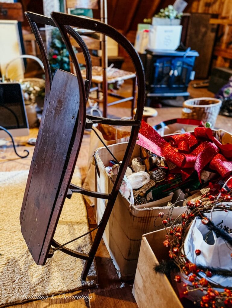 Antique wooden sled in the home's attic: vintage Christmas decorations.