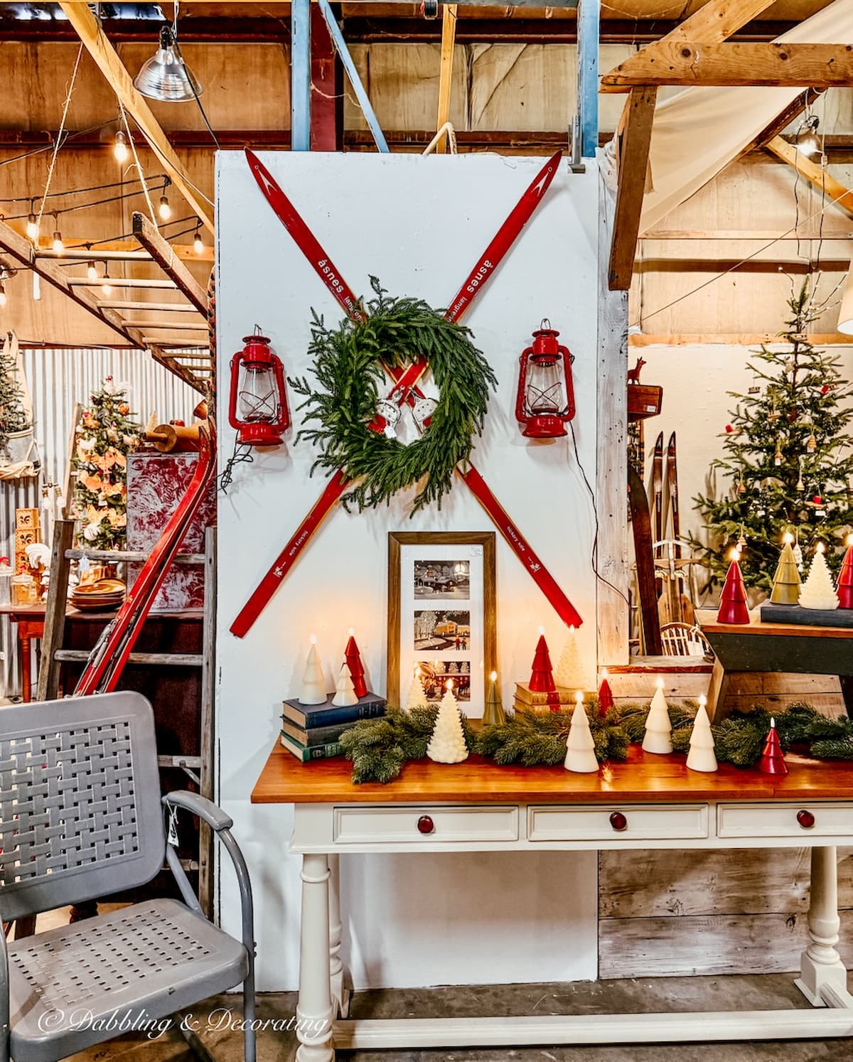 Criss crossed red skis on wall with wreath and two red lantern displayed at Barge Canal Market antiquing in Burlington, Vermont.