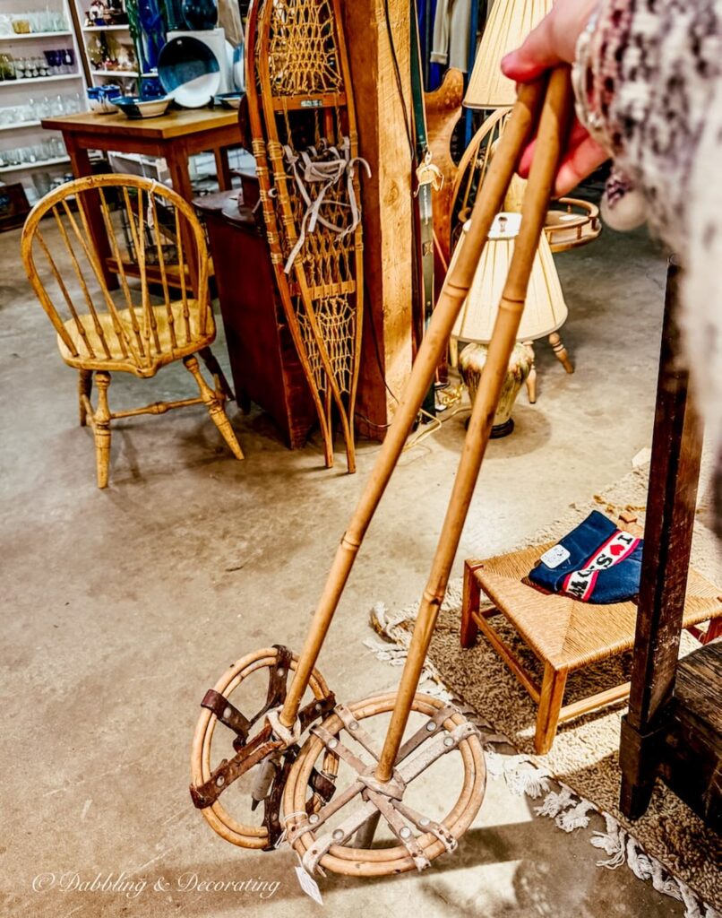 Antique wooden ski poles in hand at Barge Canal Market antiquing in Burlington, Vermont.