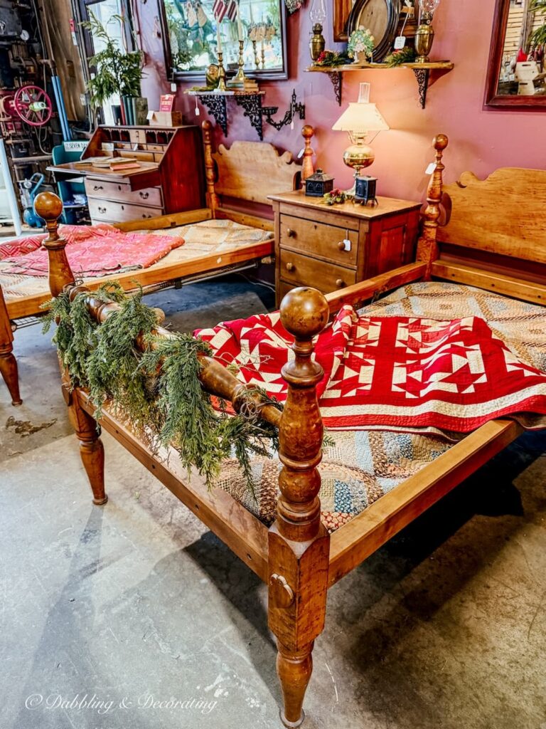 Two antique wooden rope beds on display for Christmas at Barge Canal Market antiquing in Burlington, Vermont.