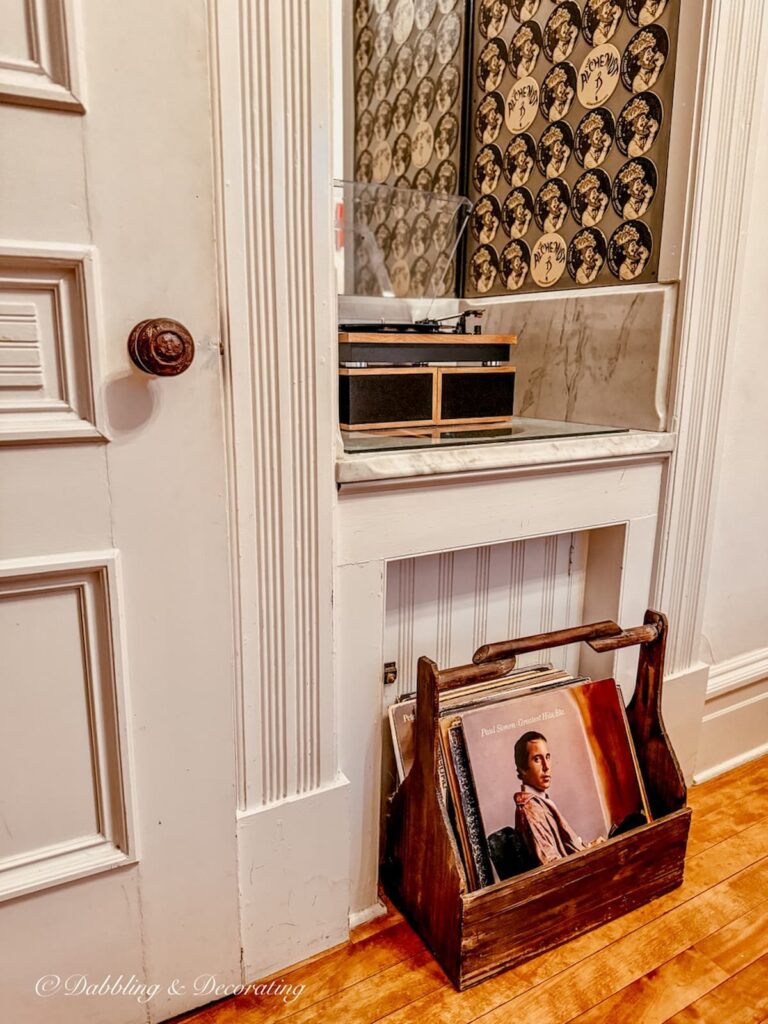 Record player and a vintage crate filled with vinyl on the floor at the Made INN in Vermont Inn in Burlington, Vermont.