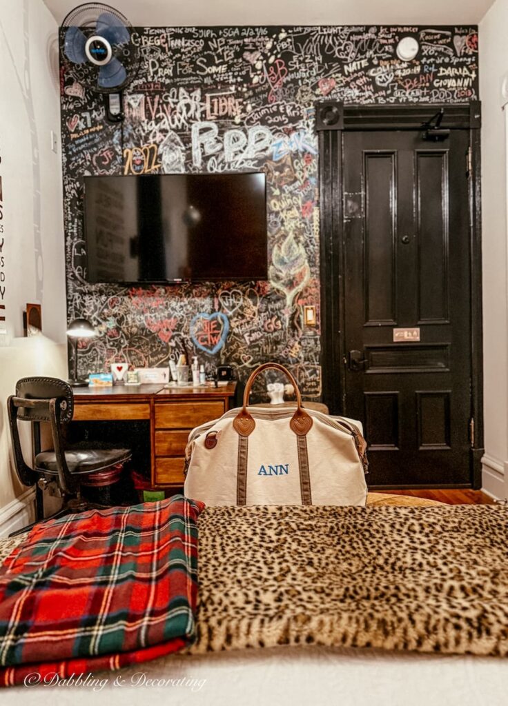 Inside the Room 903 at the Made INN Vermont with chalkboard wall and bed.