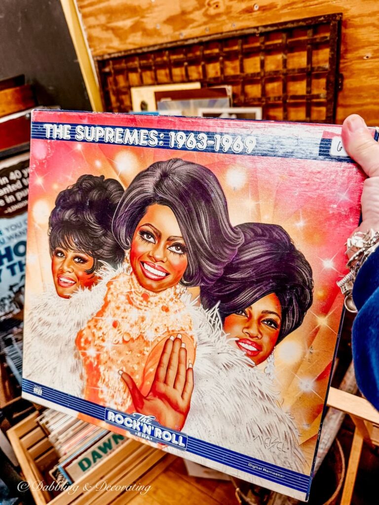 vintage The Supremes album in hand at The Vintage Inspired Marketplace antiquing in Burlington, Vermont.