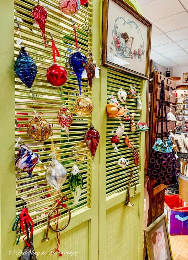 Lime green vintage shutters displaying vintage Christmas ornaments inside The Vintage Inspired Marketplace antiquing in Burlington, Vermont.