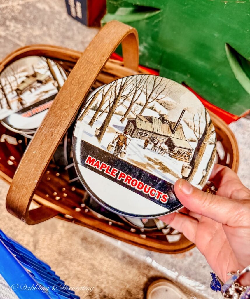 Vermont maple products tins in a basket antiquing in Burlington, Vermont at The Vintage Inspired Marketplace.