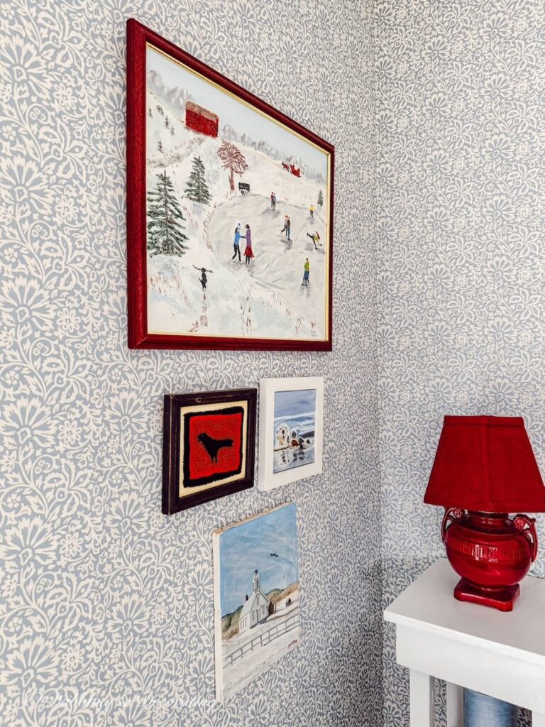 Bedroom wall with Vermont art displayed on wall.