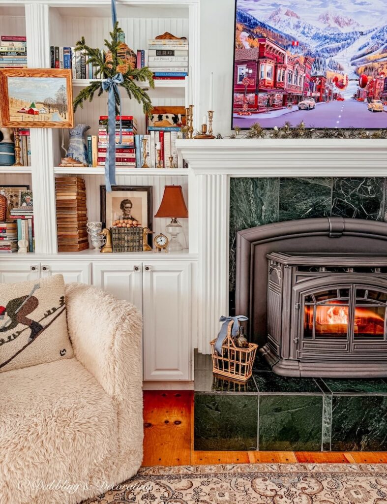 Christmas Bookshelf decor with eclectic and vintage style in cozy corner with pellet stove.