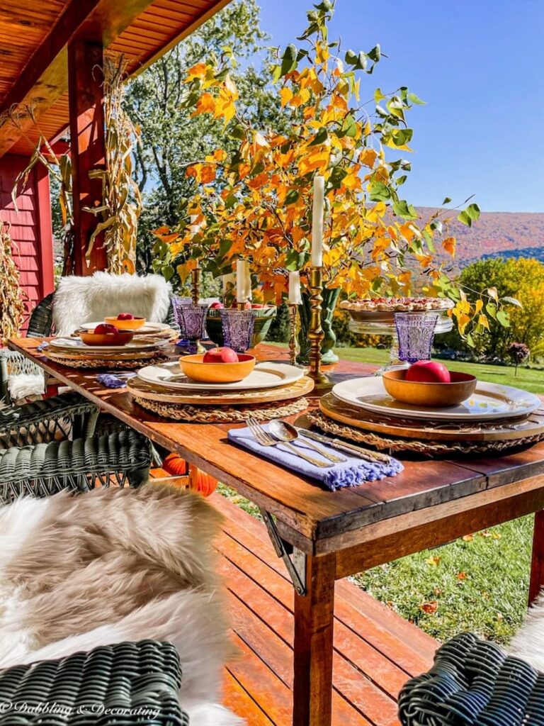 Outdoor Fall table setting with sheepskin decor ideas on Mountain home porch.