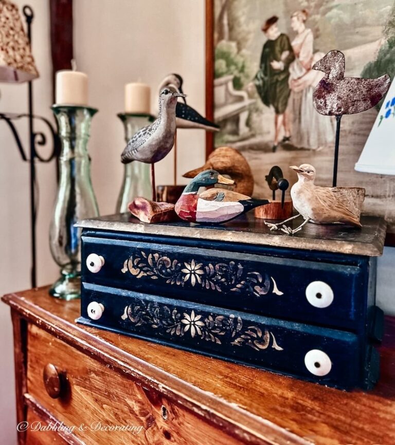 Nautical styled living room corner with vintage dresser decorating ideas with driftwood sea bird collection.