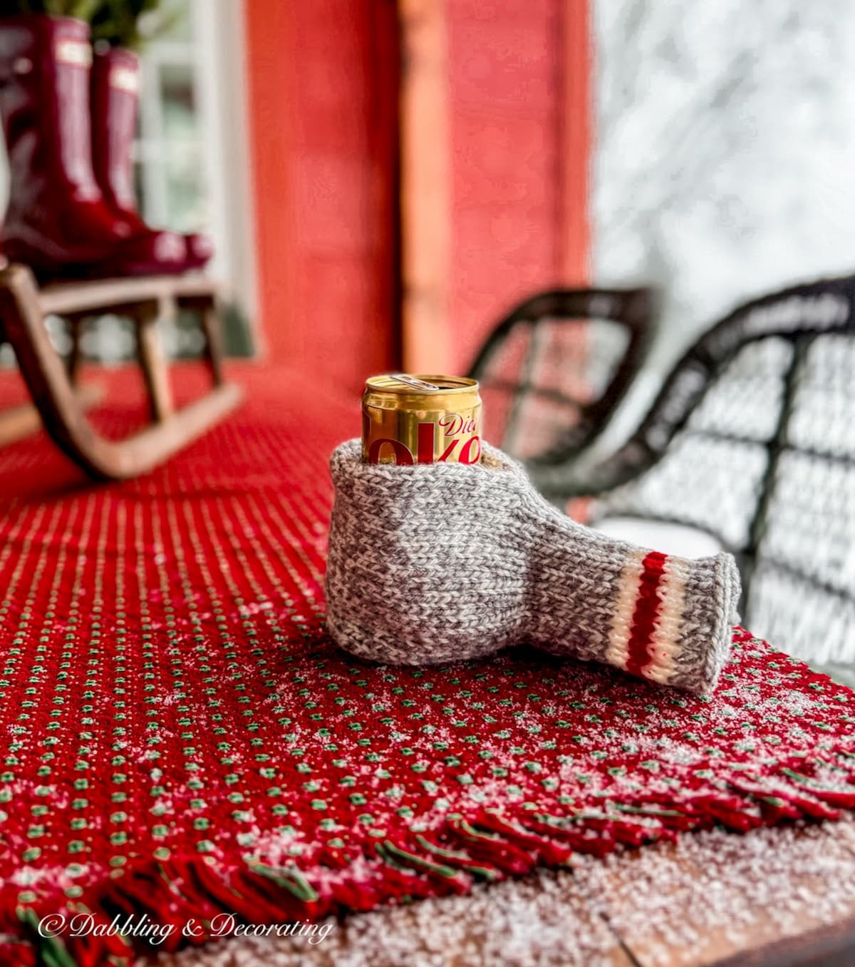Beverage mitten with Diet Coke can on Après Ski Christmas table on outdoor porch.