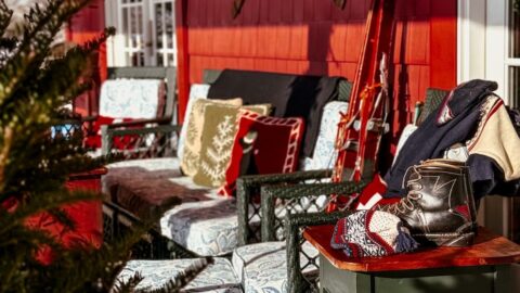 Après Ski Christmas porch decor on Vermont home's outdoor porch with vintage ski lodge decor.