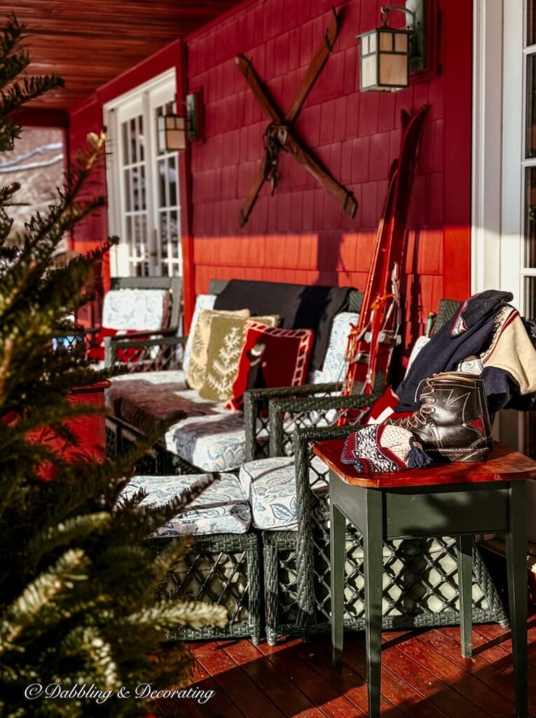 Après Ski Christmas porch decor on Vermont home's outdoor porch with vintage ski lodge decor.