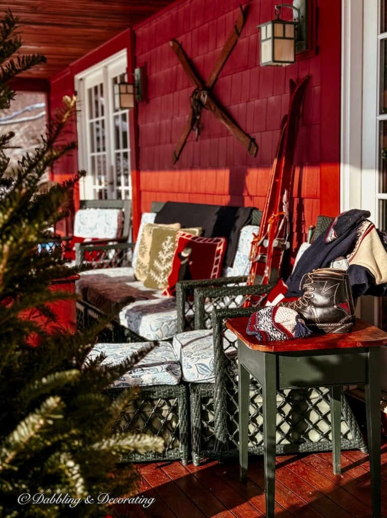Après Ski Christmas porch decor on Vermont home's outdoor porch with vintage ski lodge decor.