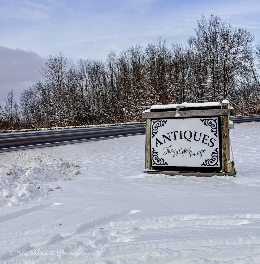 The Perfect Image Antiques sign in the snow in Pitsford, Vermont off Route 7.