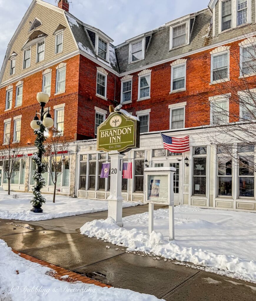 The Brandon Inn near antique shops in Brandon, Vermont in the snow.