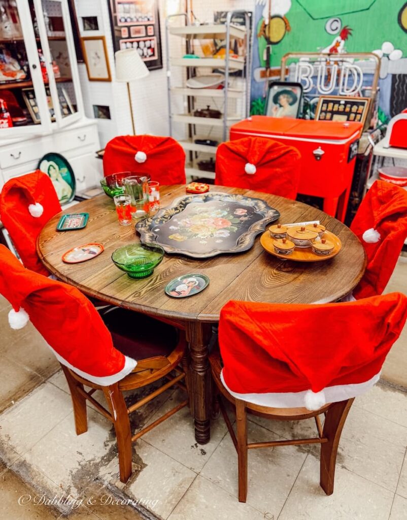 Antique shops in Brandon Vermont with table surrounded with Santa styled chairs.