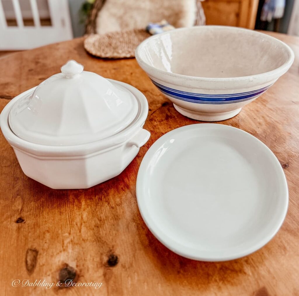 Vintage finds, a white soup tureen, restaurantware white platter and a white and a blue striped white stoneware bowl found at antique shops in Brandon, Vermont.