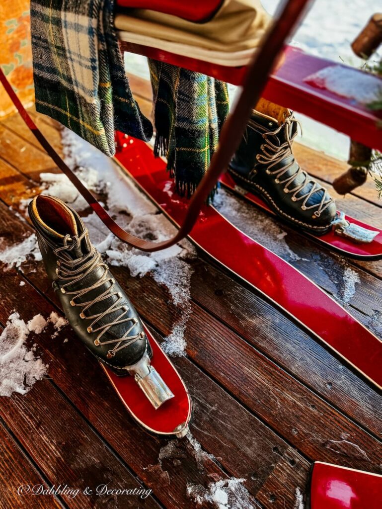 Vintage French Ski Bob in Après Ski Christmas Porch Decor with vintage black ski boots.
