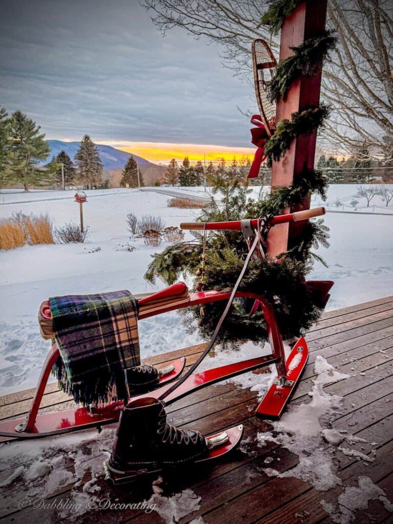 Vintage French Ski Bob displayed in Après Ski Christmas Porch Decor: Vintage Ski Lodge Style In The Vermont Mountains with mountain views.