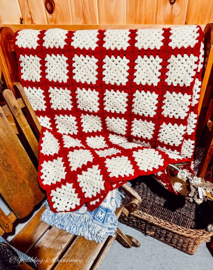 Red and white handmade afghan with squares at The Willows Flea Market in Maine.