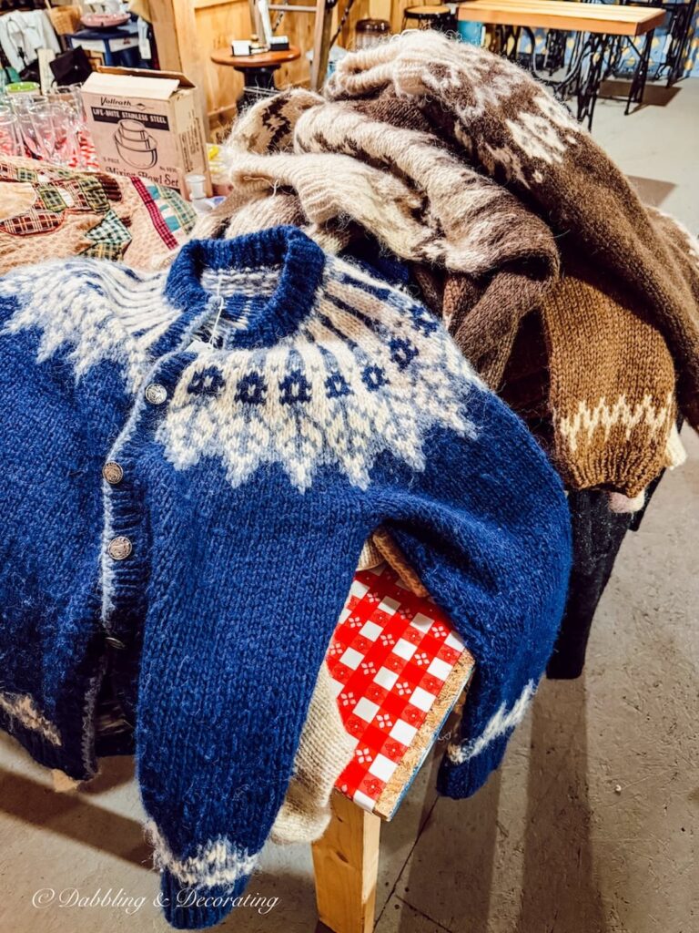 Pile of blue and brown Icelandic sweaters piled high at The Willows flea market in Maine.