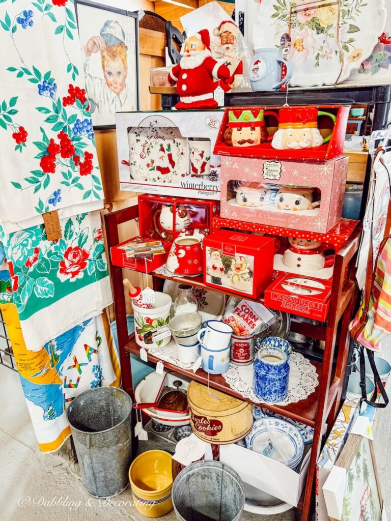 Vendor display of colorful retro kitchenware and children's dishes at The Willows Flea Market in Maine.