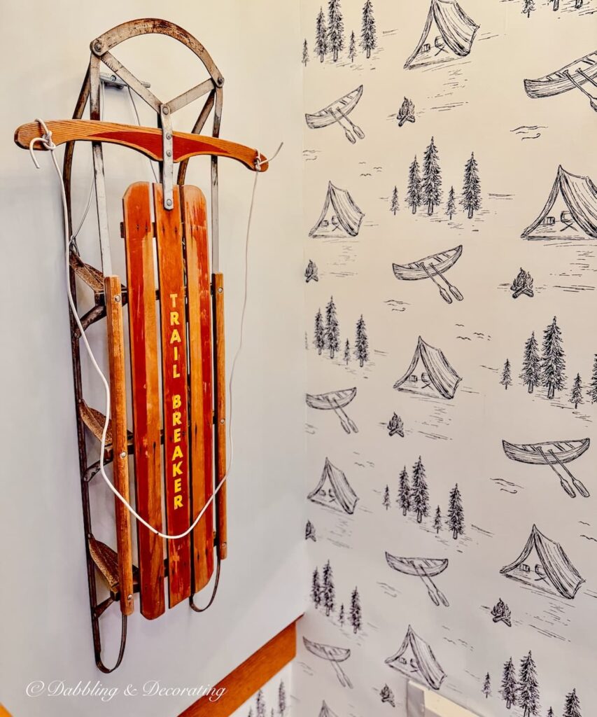 Vintage sled on the wall over staircase at the Wolf Cove Inn in Poland, Maine on Tripp Lake.