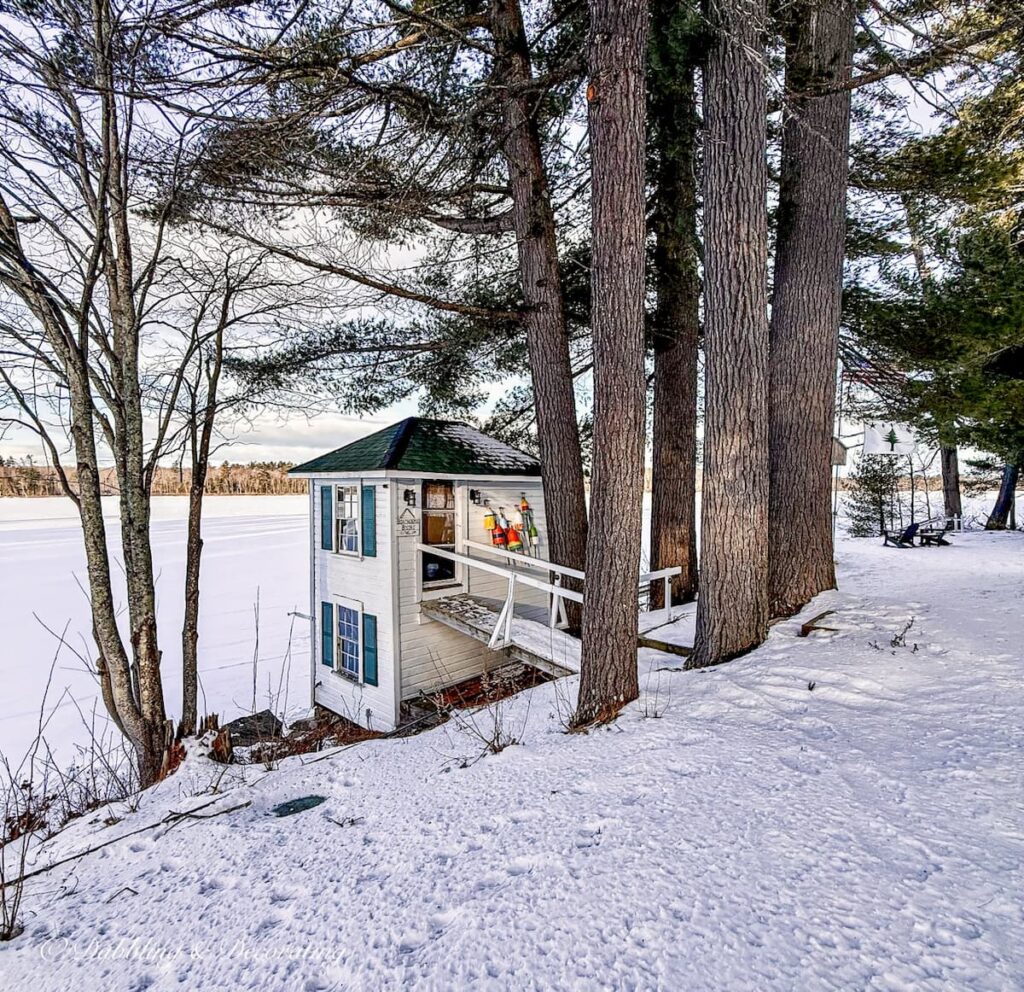 Boathouse during winter's snow on Tripp Lake in Poland, Maine at Wolf Cove Inn.