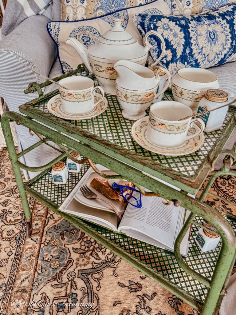 Tea cart styling ideas with green Parisian bar cart and Aynsley Banquet tea set in cozy living room.