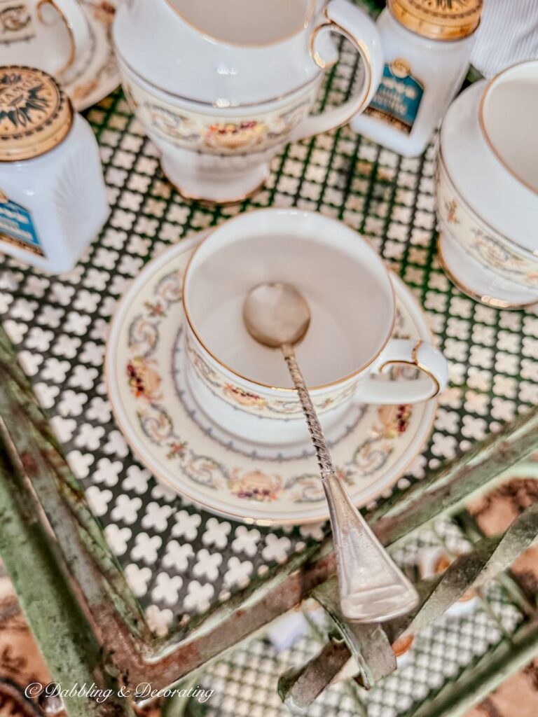 The Aynsley Banquet tea cup and saucer with a vintage silver spoon in tea cart styling ideas.