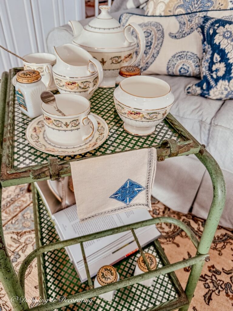 Tea cart styling ideas with vintage tea towel with blue embroidered diamond on antique bar cart with Aymsley's Banquet tea set.