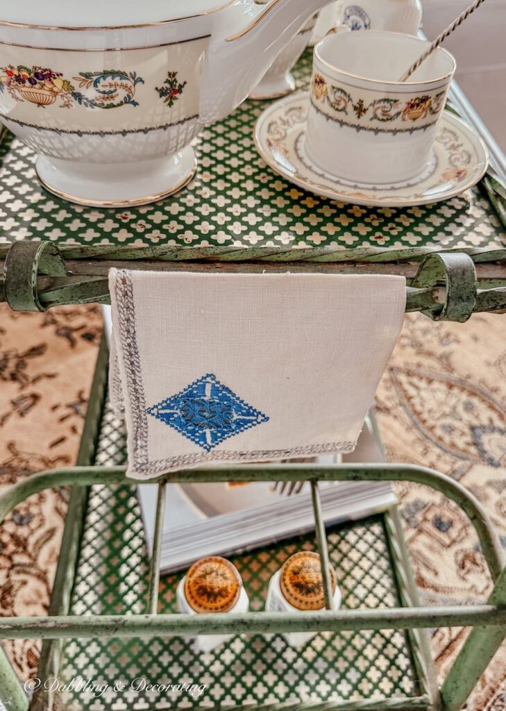 Tea cart styling ideas with Aynsley's Banquet tea set, vintage tea towel on green antique bar cart.