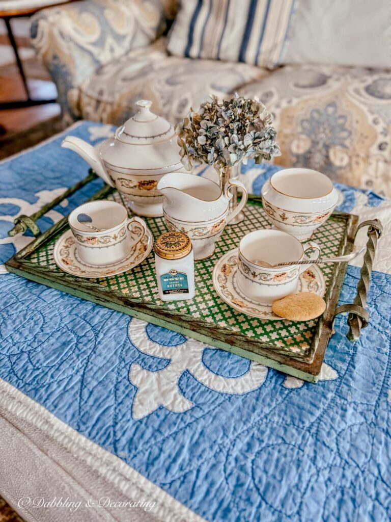 Antique green tray from bar cart styled on living room ottoman with Ansley's Banquet tea set.