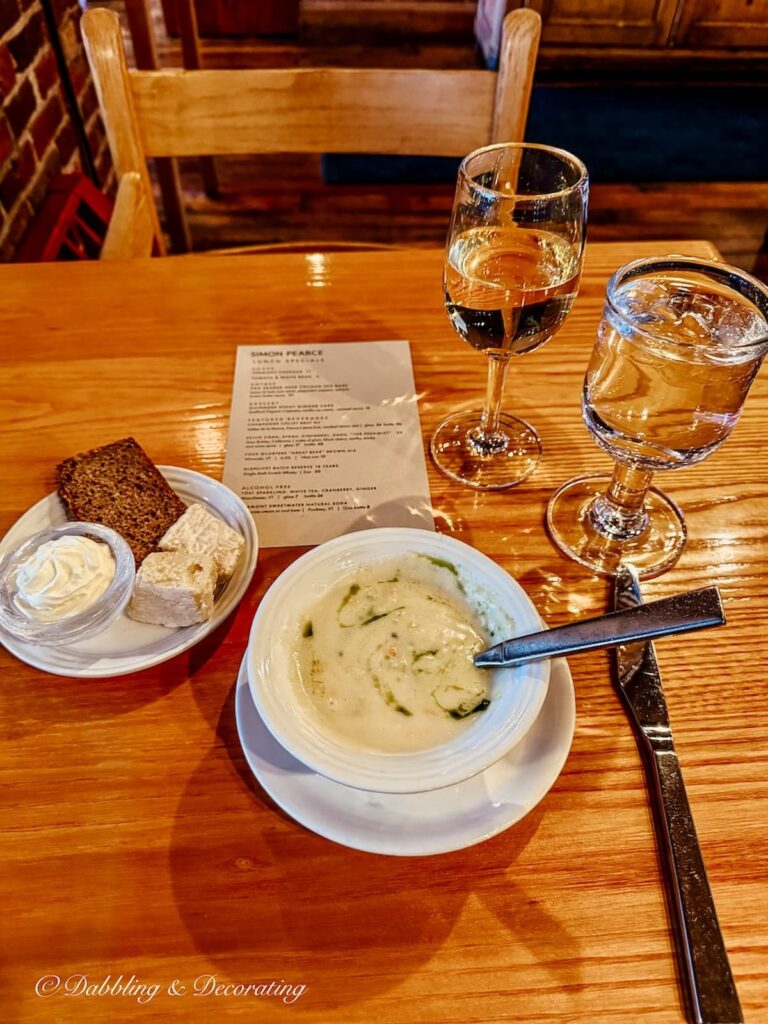 Vermont cheddar soup and bread on table at Simon Pearce, Quechee, Vermont after antiquing at Vermont Antique Mall in Quechee, Vermont.
