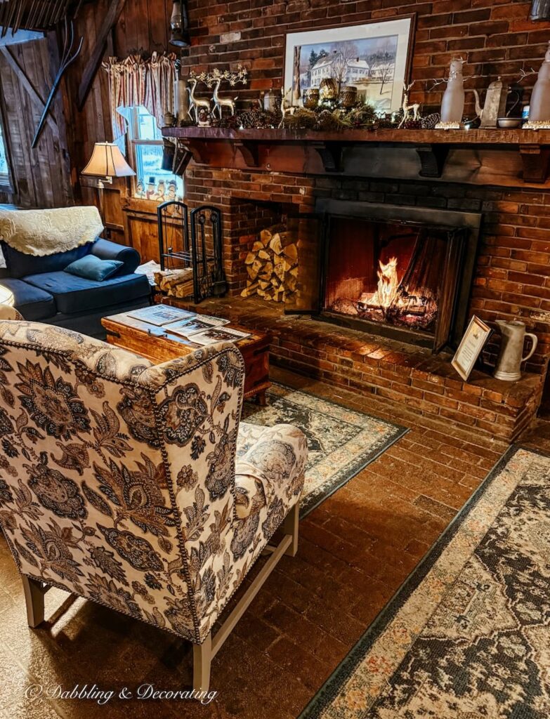 Common area with cozy fireplace at the Quechee Inn at Marshland Farm in Vermont.