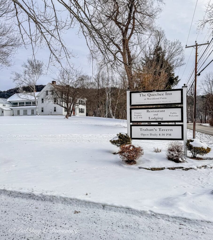Quechee Inn at Marshland Farm entryway sign during winter's snow.