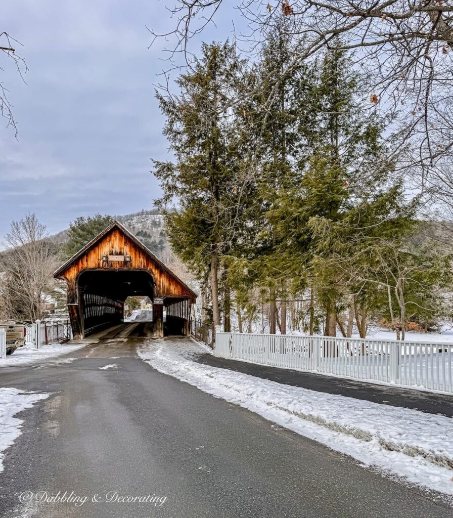 Covered bridge in the snow in downtown Woodstock, Vermont across from the Woodstock Inn.