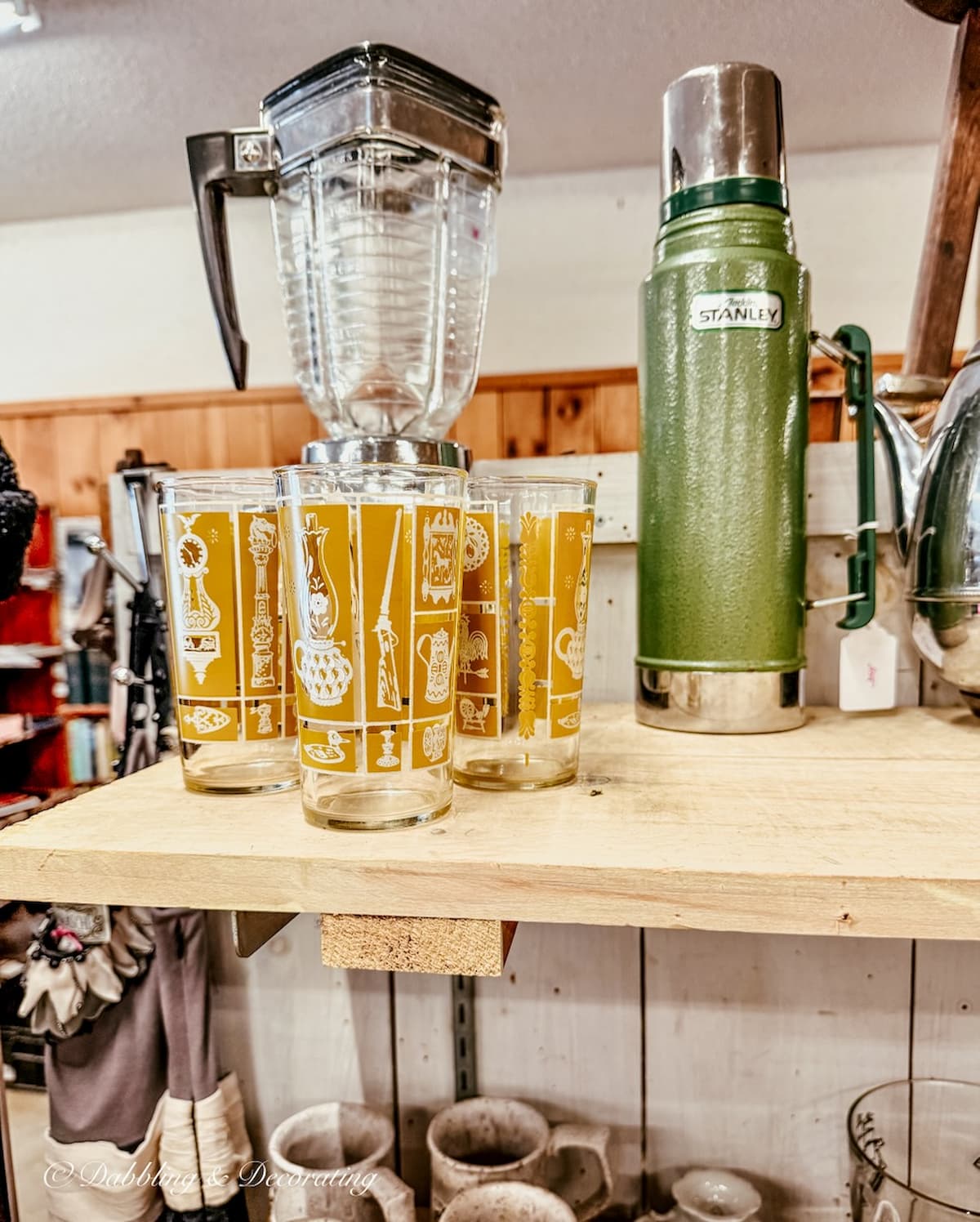 Vintage glassware with blender and thermos on antique store for apres ski decor ideas.