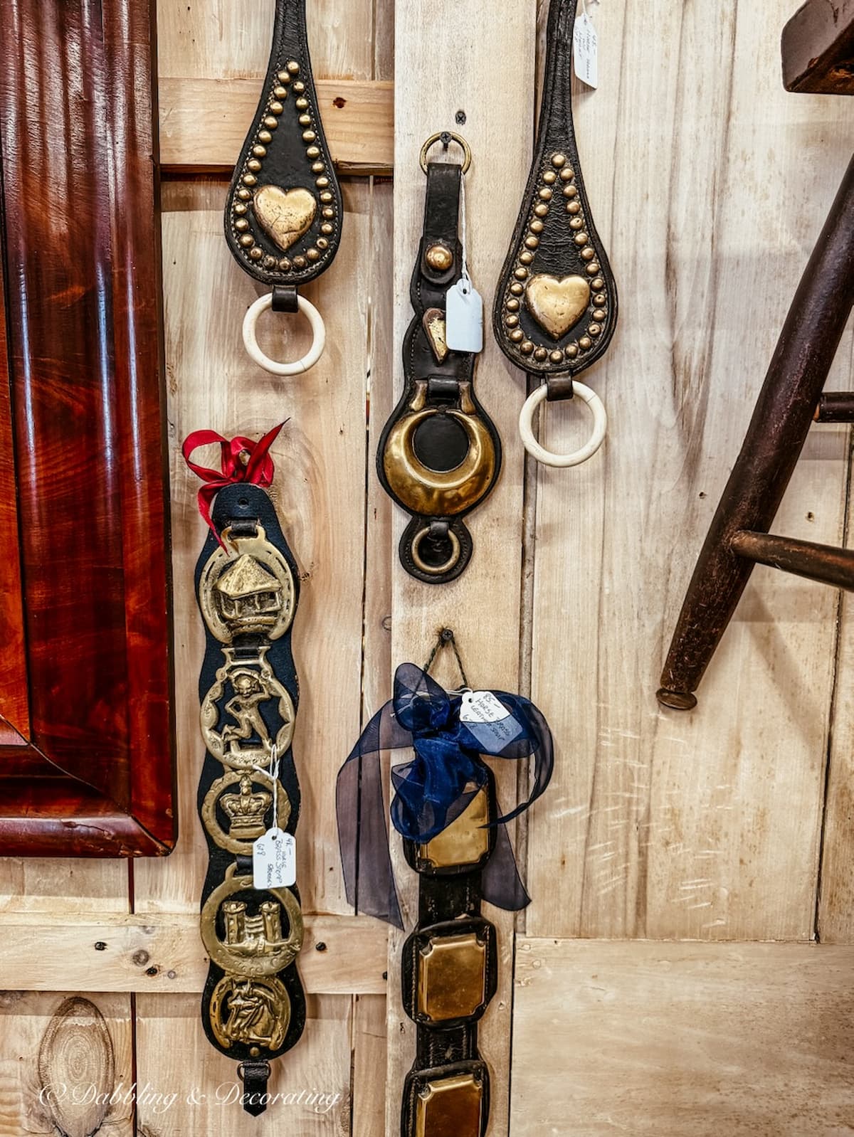 Vintage leather horse straps with brass details hanging in antique stores, great for apres ski decor.