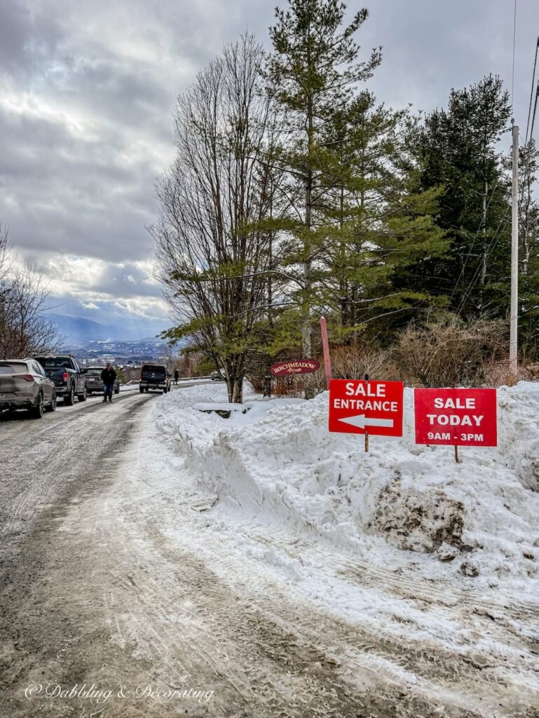 Burgess Estate Sales sign to luxury estate sale in Vermont's snow.